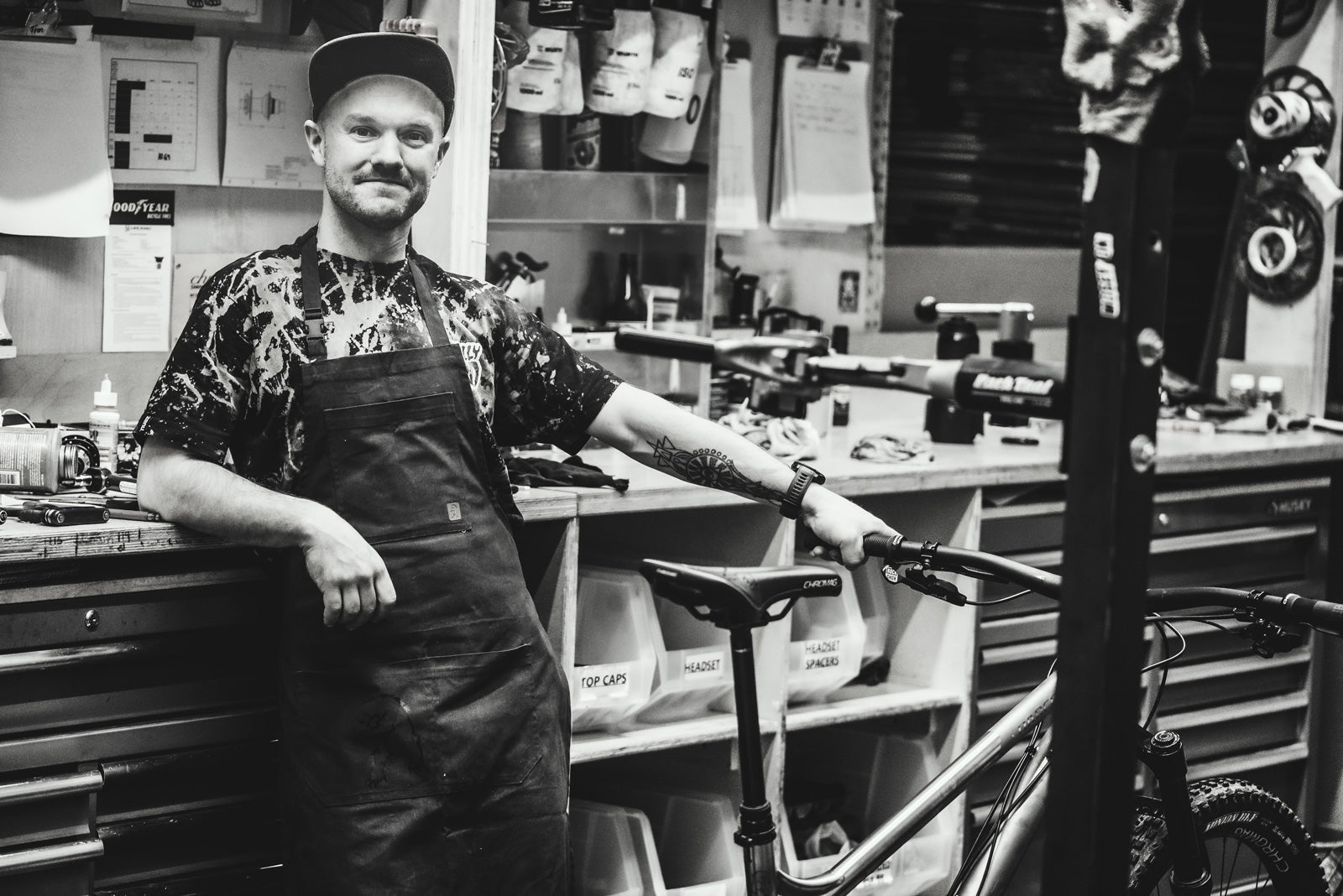 Man in a workshop with tools and a bicycle